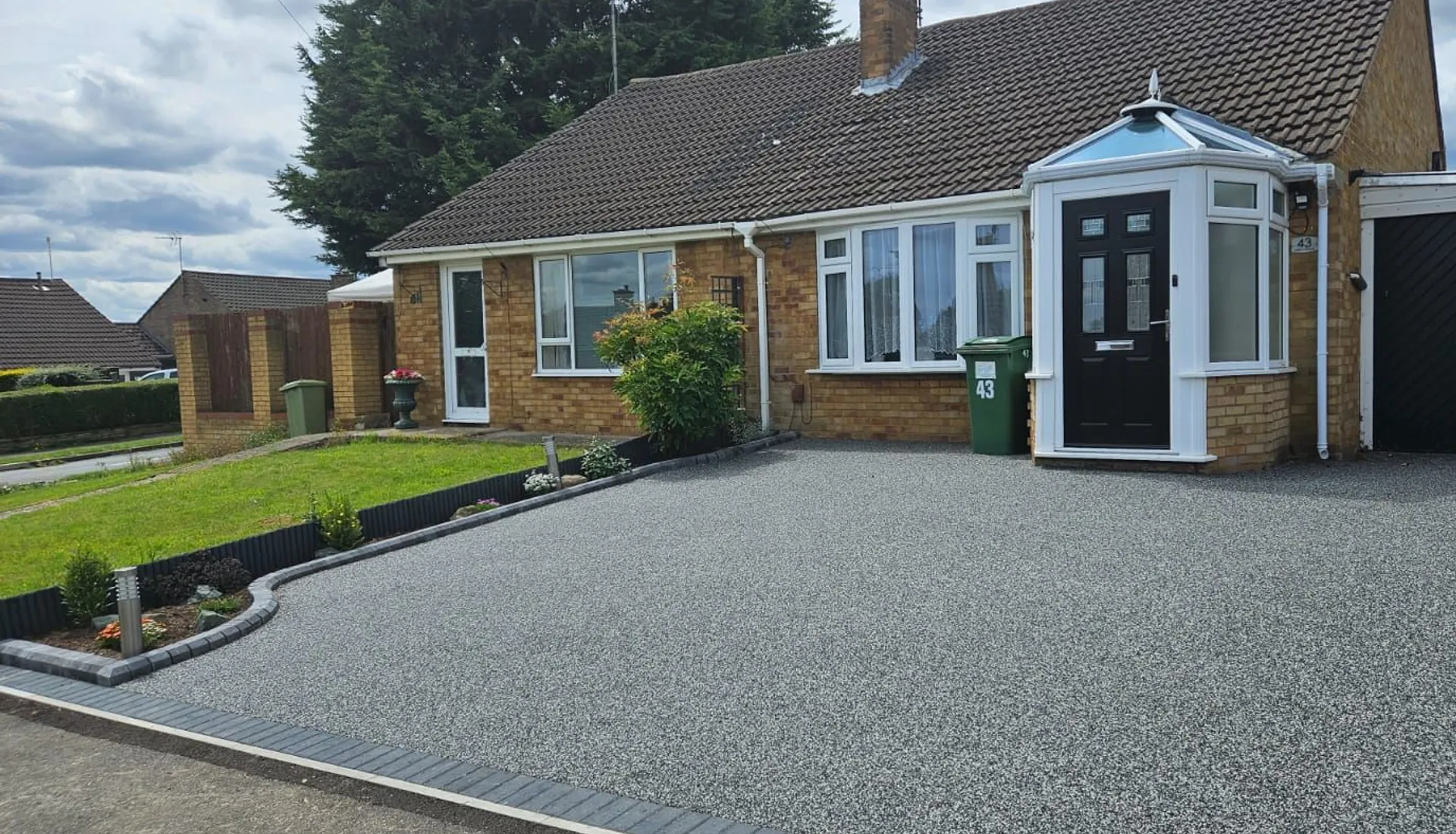 Grey resin driveway laid by Prime Paving and Resin at a bungalow